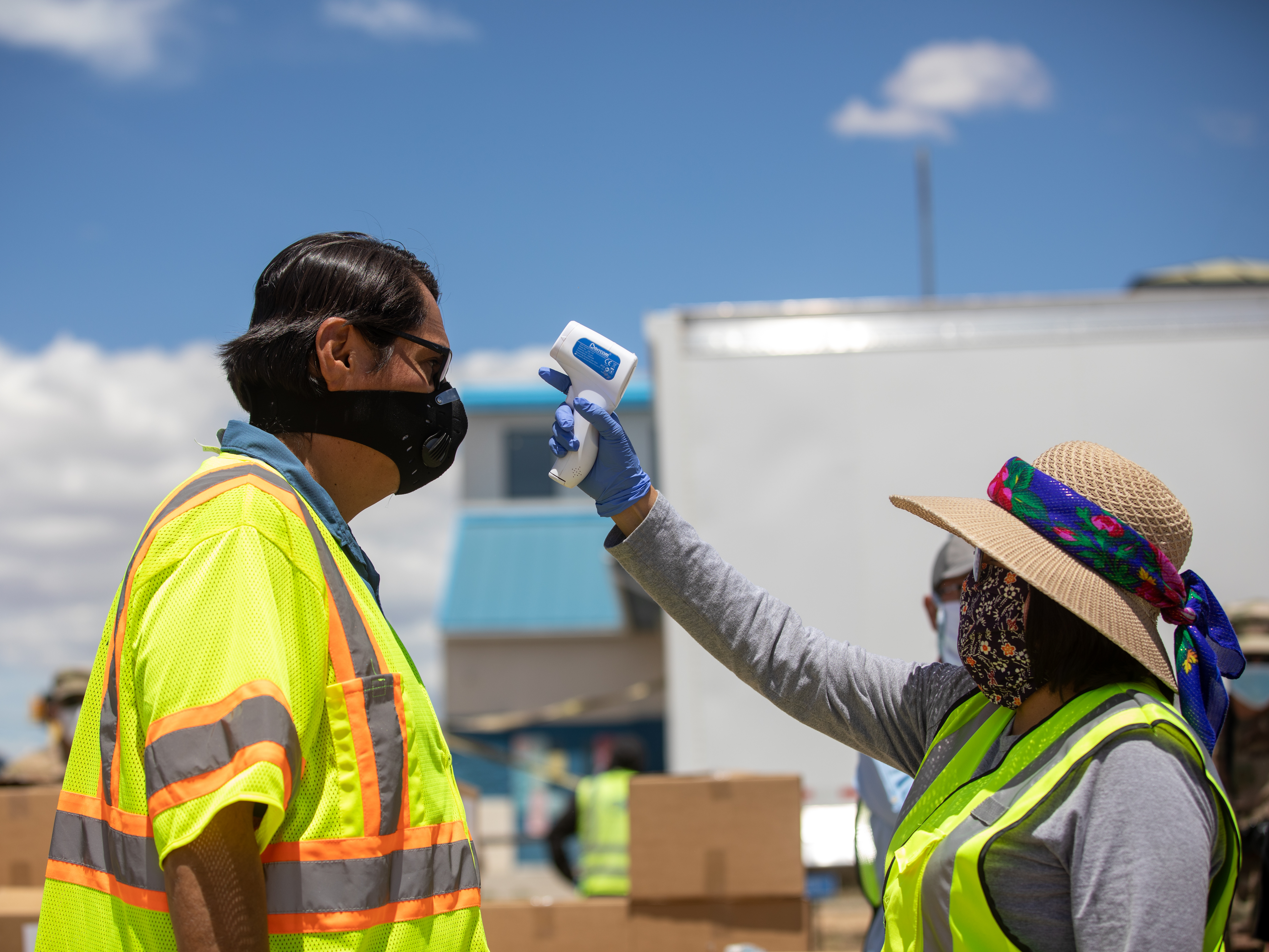 caption: Navajo Nation President Jonathan Nez has his temperature taken to check for coronavirus symptoms in May.