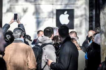 People line up outside the new Apple store on its opening day in Paris in 2017.