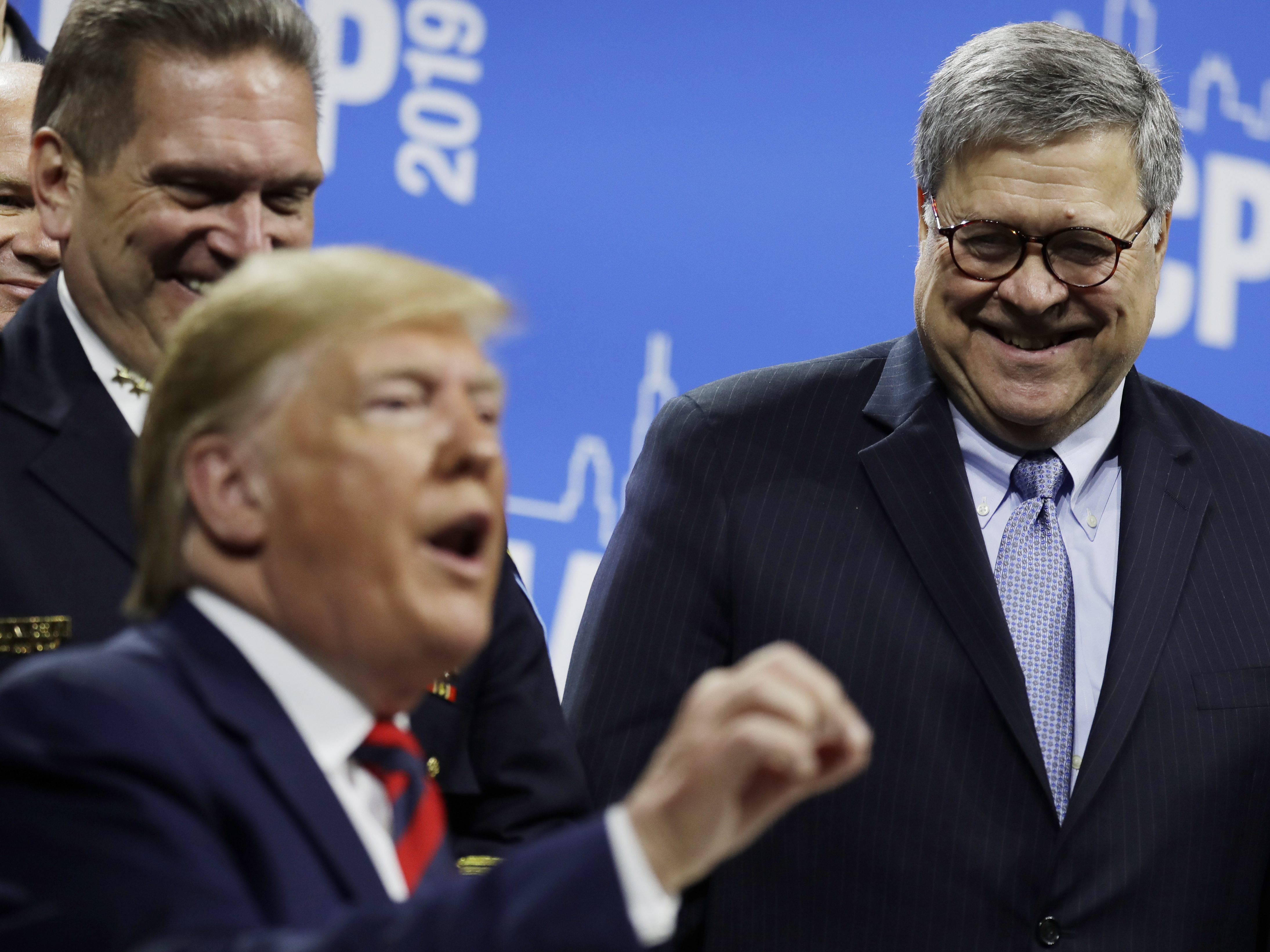 caption: Attorney General William Barr with President Trump at the International Association of Chief of Police conference on Oct. 28. The men have a better relationship than Trump did with Jeff Sessions.