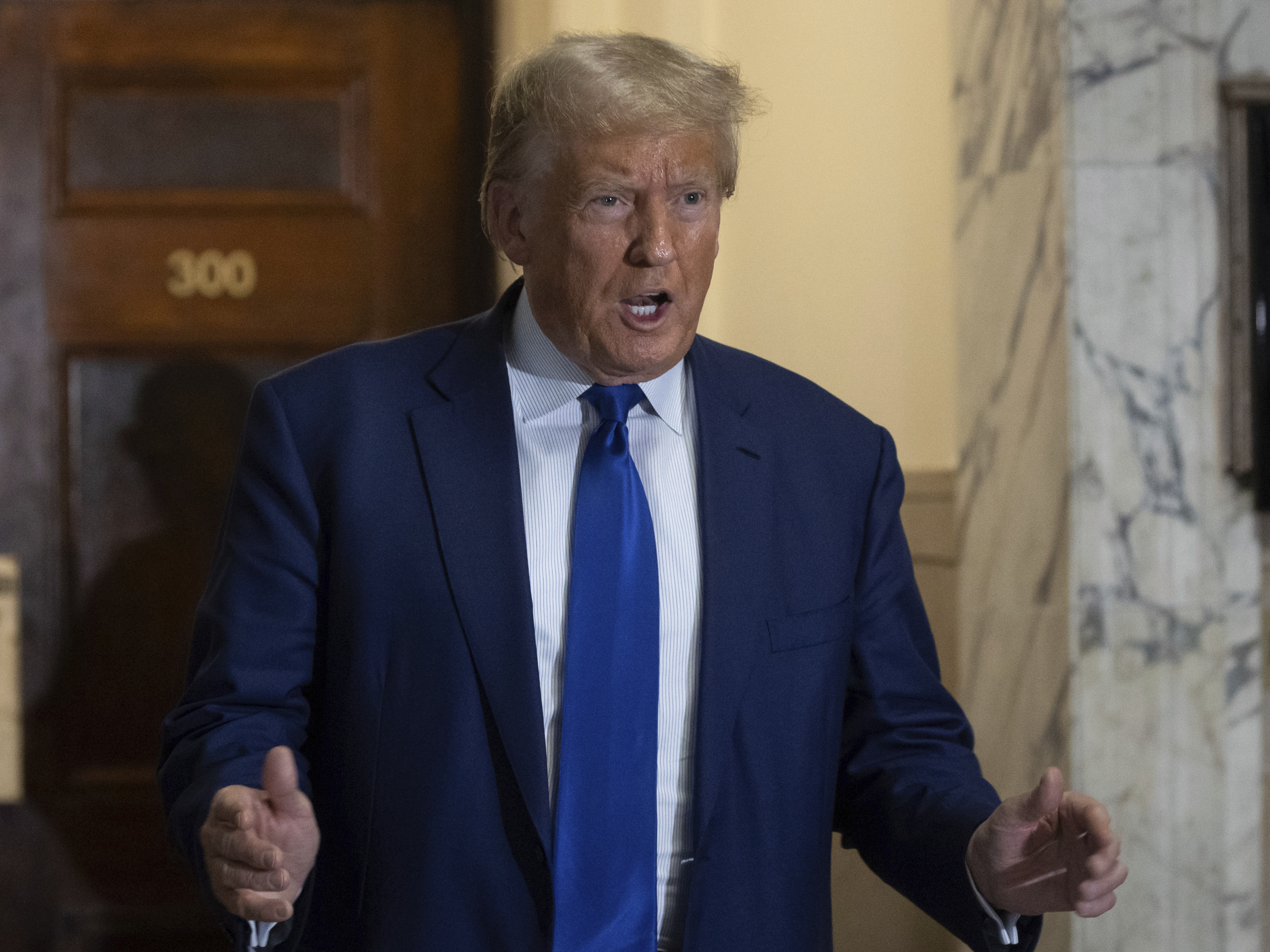 caption: Former President Donald Trump arrives at the courtroom for his civil business fraud trial at New York Supreme Court on Oct. 25, 2023.