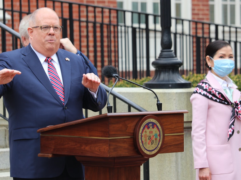 caption: Maryland Gov. Larry Hogan speaks at a news conference on Monday in Annapolis, Md., with his wife, Yumi Hogan (right), where the governor announced Maryland has received a shipment from a South Korean company to boost the state's ability to conduct tests for COVID-19 by 500,000.