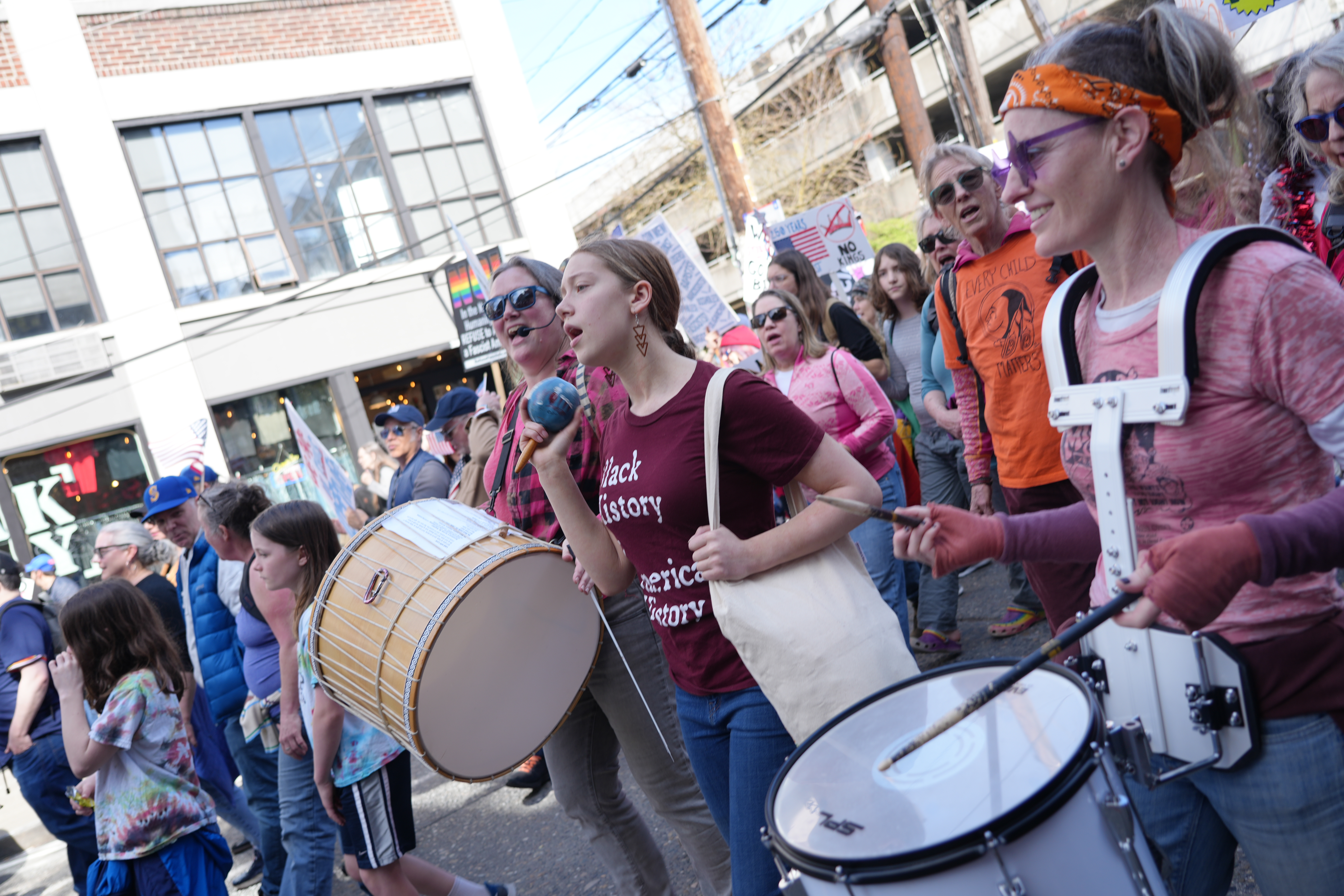 caption: Singing Resistance Seattle members demonstrate on March 28, 2026, at a No Kings protest.