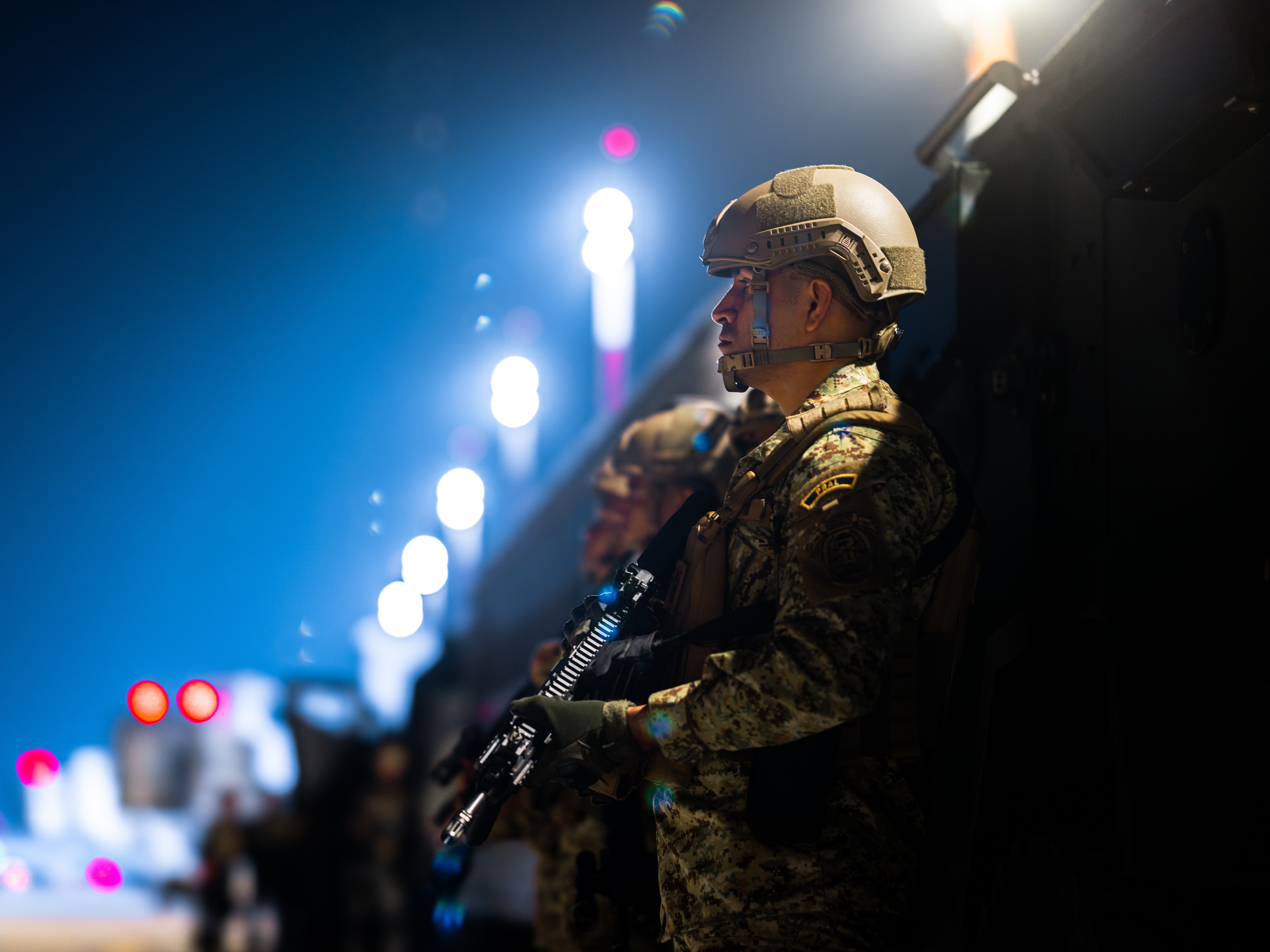 caption: Members of the Salvadoran army stand guard at the CECOT prison in Tecoluca, El Salvador, on March 16. The Trump administration deported alleged members of the Tren de Aragua gang and others to El Salvador.