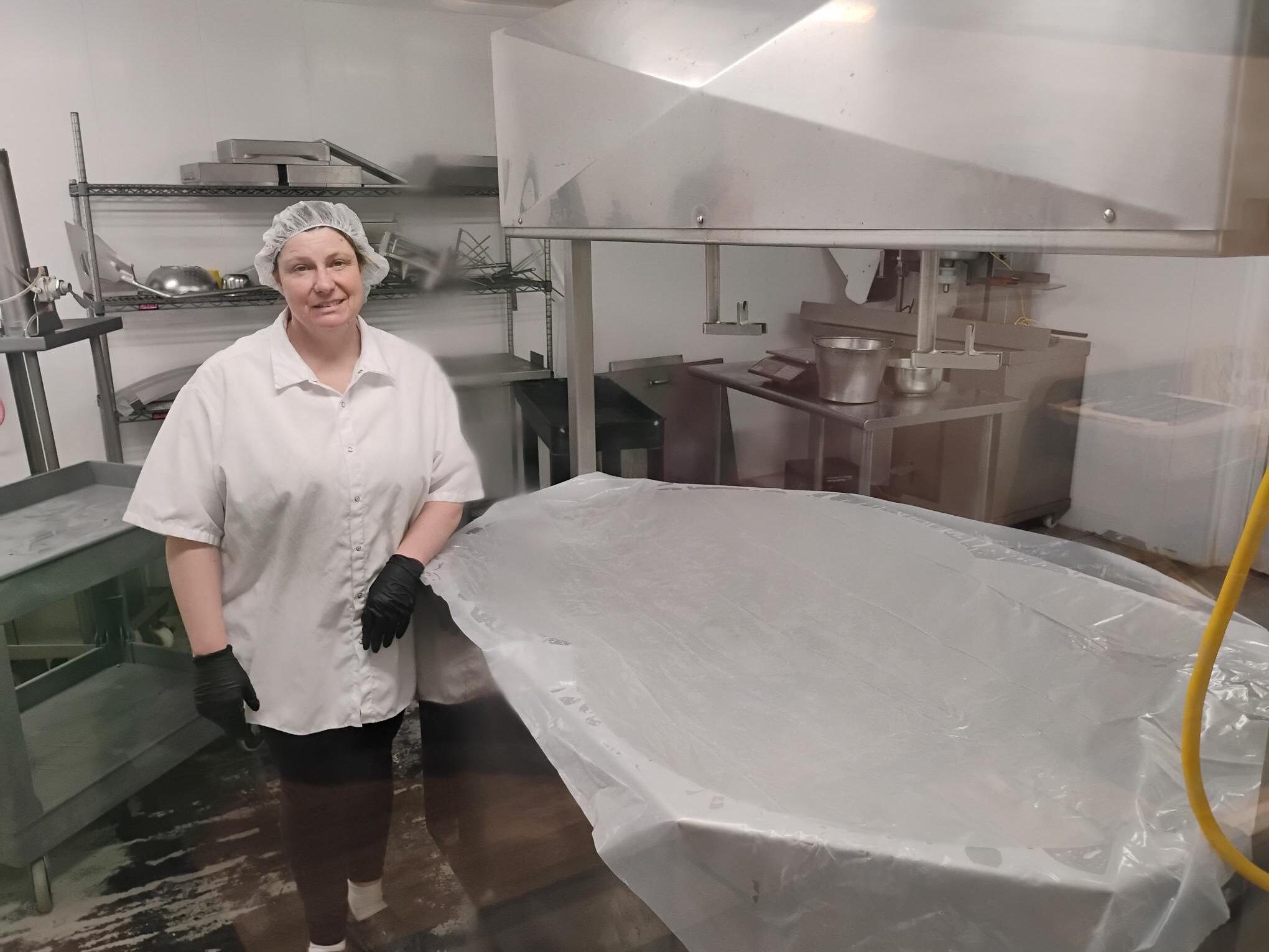 caption: Tammy Fritsch, a dairy farmer from Freedom, Wisc., stands next to her cheese vat. She has been waiting on thousands of dollars in promised federal funds. On Friday, the USDA released those funds to farmers like Fritsch.