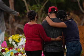 caption: Relatives attend a COVID-19 victim's burial at a cemetery in Manaus, Amazonas state, Brazil, on Thursday.