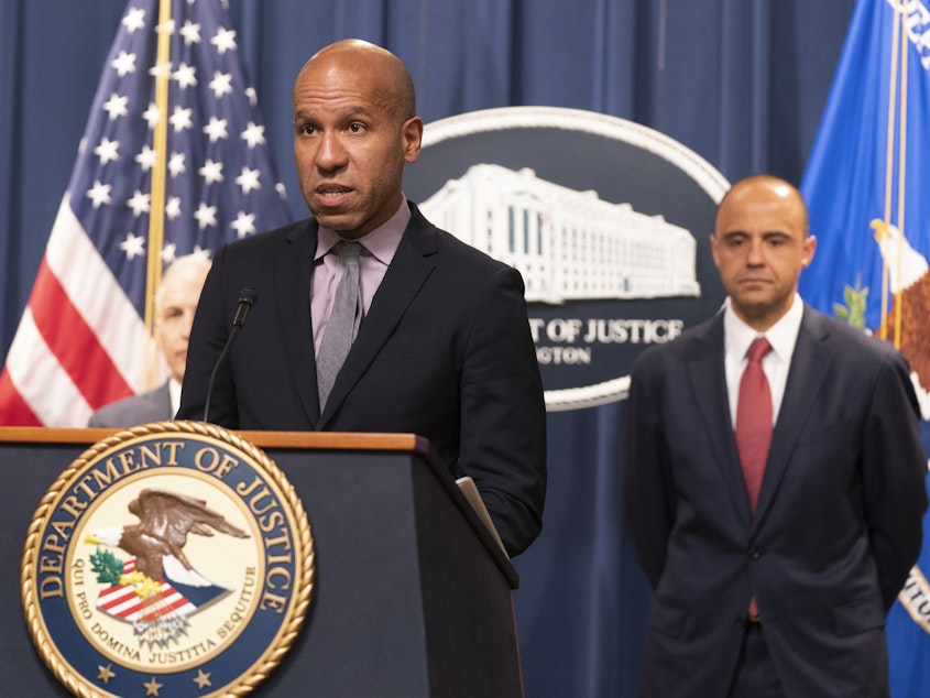 caption: Under Secretary of the Treasury for Terrorism and Financial Intelligence Brian Nelson, with U.S. Attorney Matthew Graves for the District of Columbia, speaks during a news conference on Tuesday at the Department of Justice in Washington.