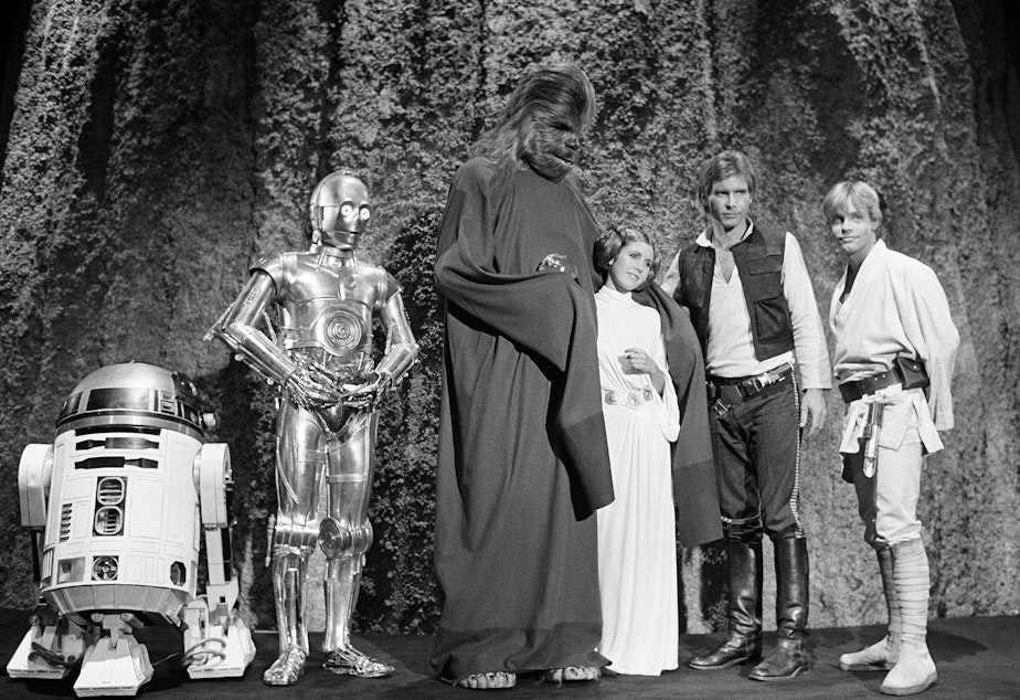 FILE - In this Nov. 13, 1978 file photo, shows, from left, Kenny Baker, Anthony Daniels, Peter Mayhew, Carrie Fisher, Harrison Ford, and Mark Hamill during the filming of the CBS-TV special "The Star Wars Holiday" in Los Angeles. On Tuesday, Dec. 27, 2016, a publicist says Fisher has died at the age of 60.