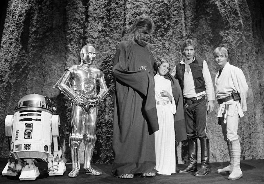 caption: FILE - In this Nov. 13, 1978 file photo, shows, from left, Kenny Baker, Anthony Daniels, Peter Mayhew, Carrie Fisher, Harrison Ford, and Mark Hamill during the filming of the CBS-TV special "The Star Wars Holiday" in Los Angeles. On Tuesday, Dec. 27, 2016, a publicist says Fisher has died at the age of 60. 