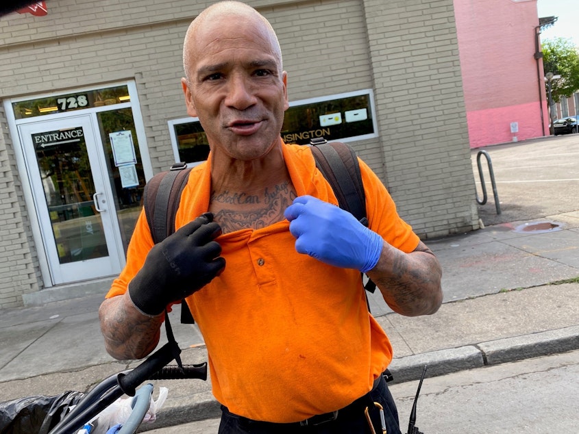 caption: Bobby Parker, showing off his tattoo that reads "Only God Can Judge Me," says he had to sleep outside when he was locked out of his New Orleans home.