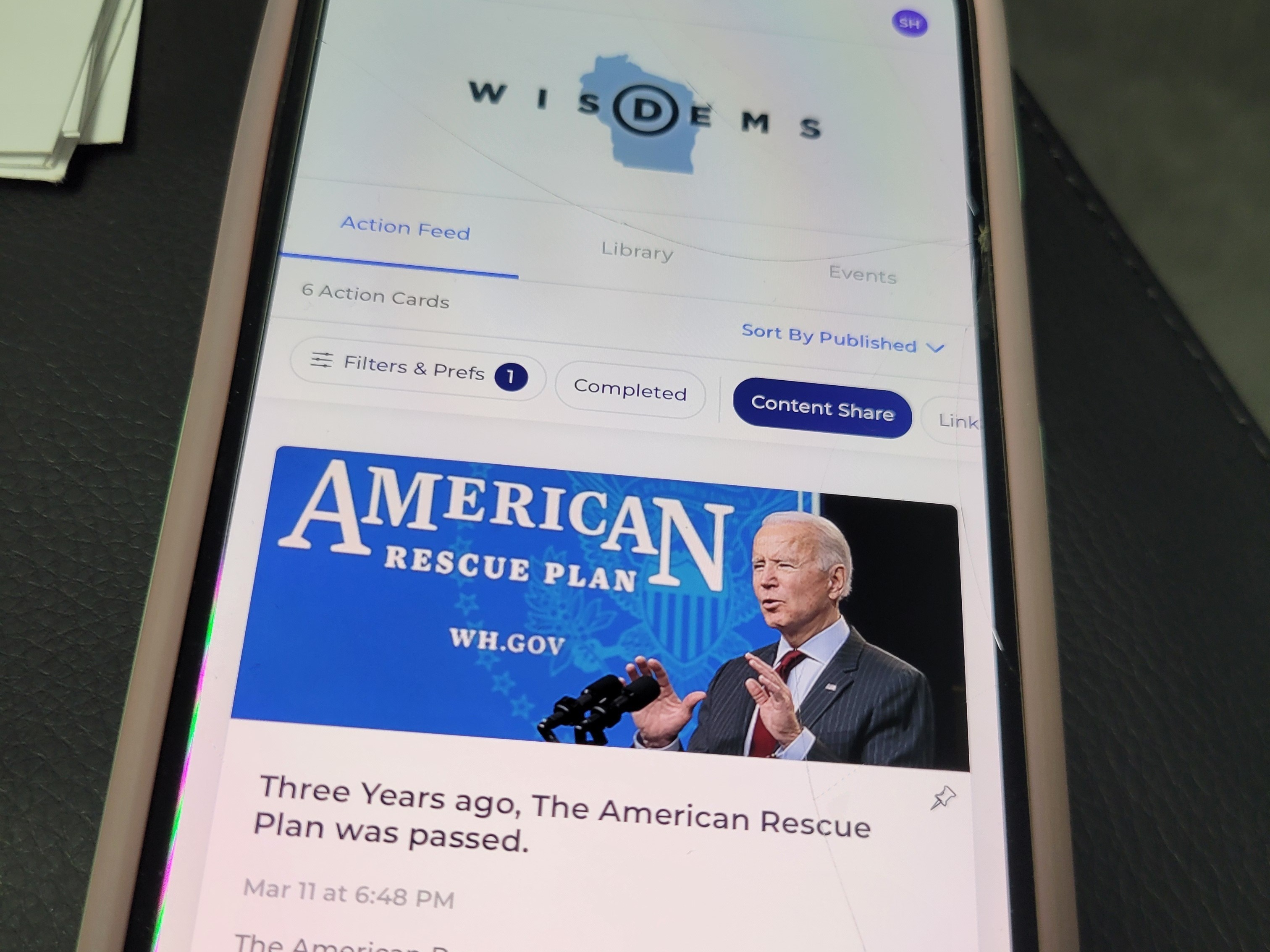 caption: The Reach app, as seen on volunteer Sarah Harrison's phone, allows Biden supporters to share content directly with their contacts, and is connected to a national Democratic party voter database.