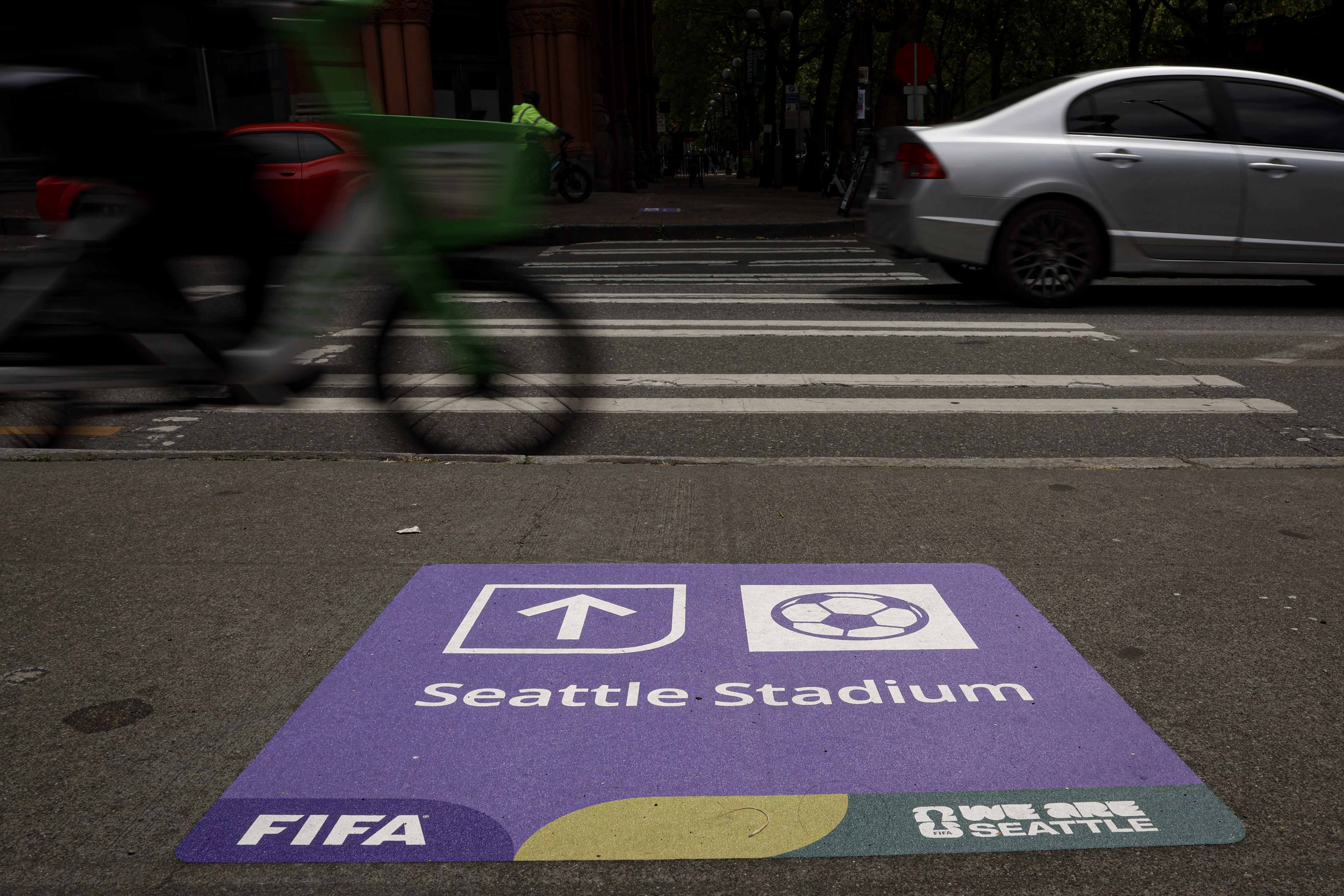 caption: A sign points the way to Seattle Stadium in the Pioneer Square area. Seattle is hosting 6 matches of the FIFA World Cup 2026. June 5, 2026, Seattle.