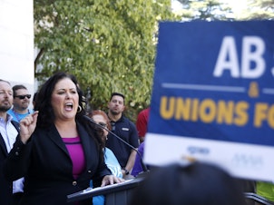caption: Democratic Assemblywoman Lorena Gonzalez speaks at a July rally for independent contractors in Sacramento, Calif. The measure that passed Tuesday in the state Senate requires companies such as Lyft and Uber to turn many contract workers into employees.