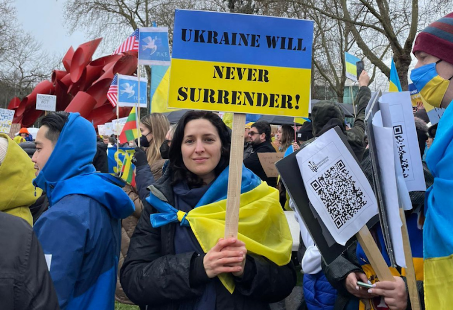 caption: Olena Bidovanets protests in Seattle in solidarity with her home country, Ukraine. 