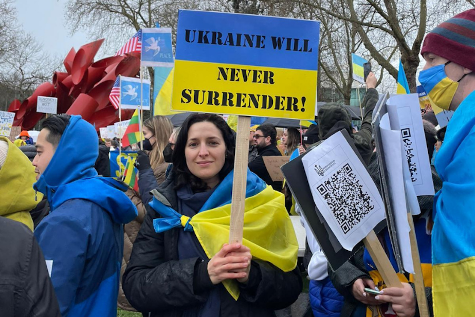 caption: Olena Bidovanets protests in Seattle in solidarity with her home country, Ukraine. 