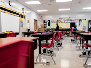caption: A Louisville, Ky., classroom sits empty in January 2022, during a COVID surge driven by the omicron variant. Students lost the routine of going to school during the pandemic, and now many are struggling to get back in the habit.