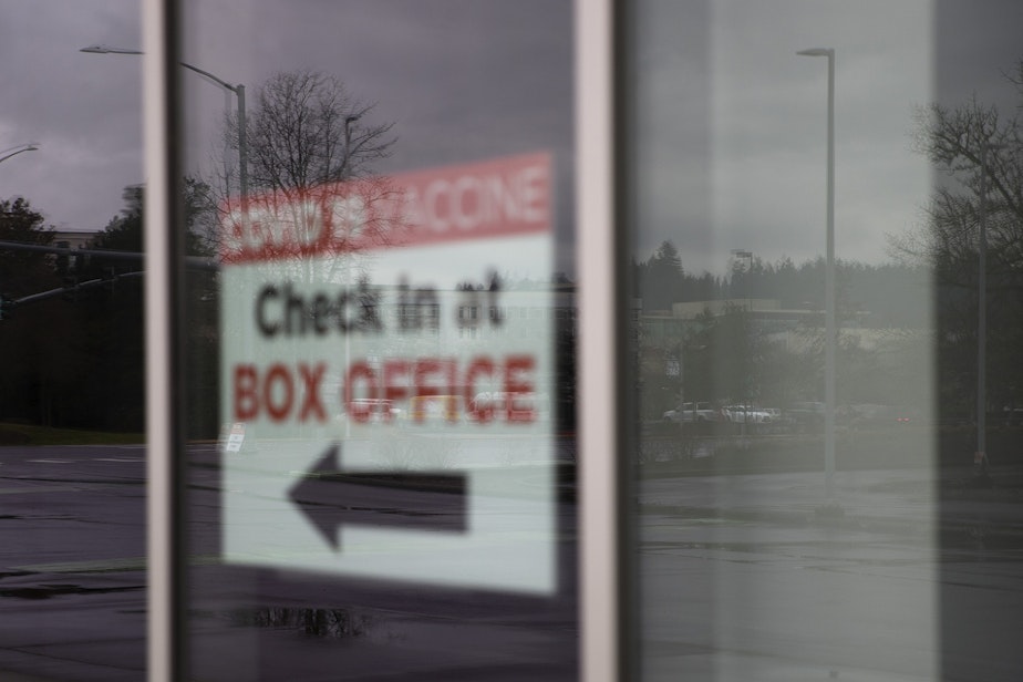caption: A sign let's people know to check in at the Box Office for a Covid-19 vaccine, on Monday, February 1, 2021, at a new vaccination site at the ShoWare Center in Kent. Six days a week, 500 doses per day will be administered at the site. 