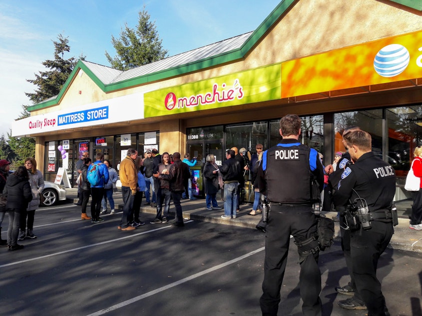 caption: Kirkland Police joined neighbors and supporters of Ragland outside Menchie's Tuesday. One Kirkland resident said she wants to see the shop owner out of a job.