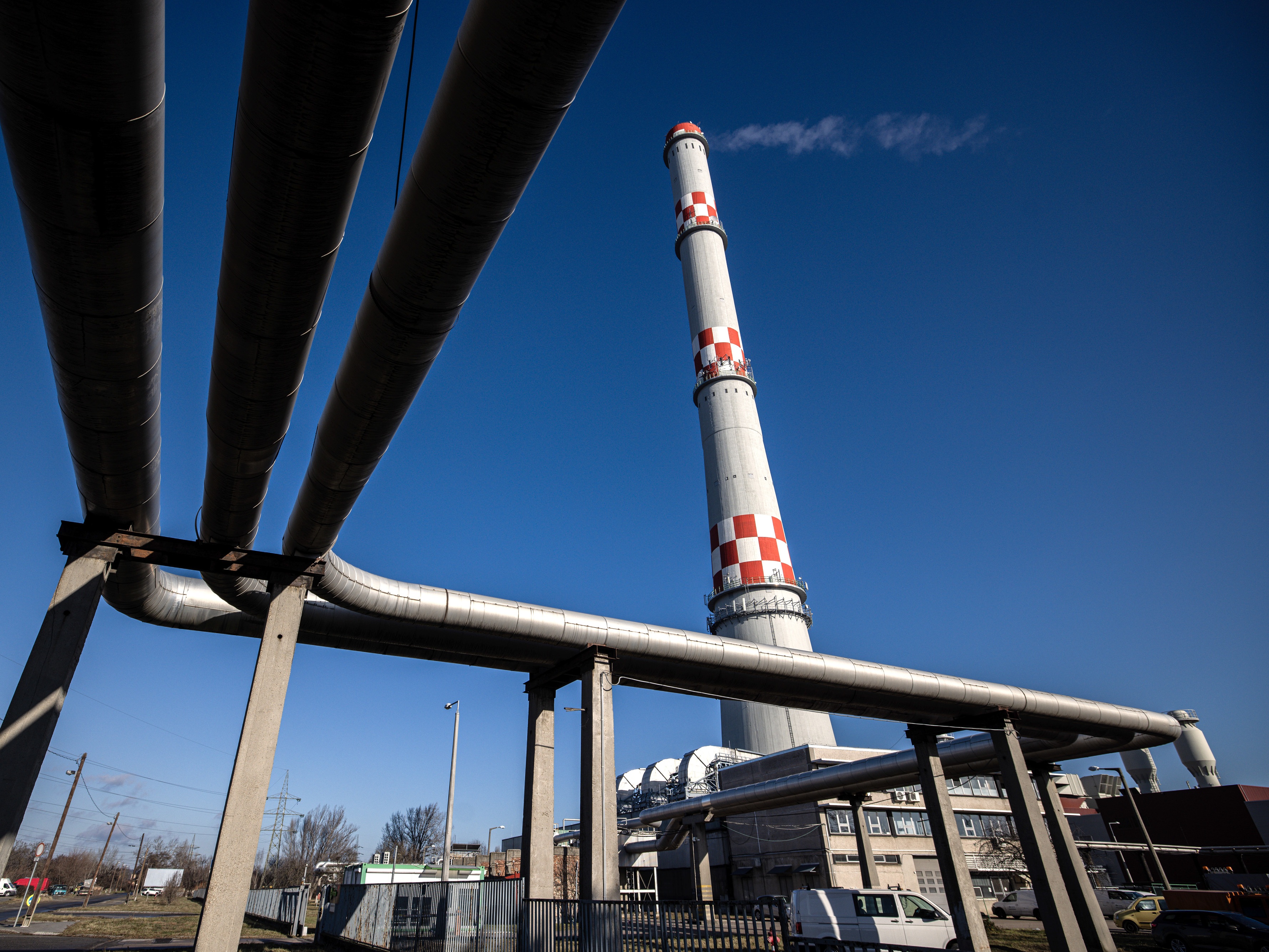 caption: A chimney and pipes of the BKM Nonprofit Fotav Zrt power plant in Budapest, Hungary, on Jan. 3. The subzero temperatures coincide with the end of the Russia-Ukraine pipeline transit deal, leaving the region without a key source of gas supply.