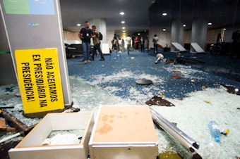 caption: Damage is seen at Brazil's Congress one day after supporters of former President Jair Bolsonaro stormed government buildings in Brasília. The attack was planned by far-right groups on social media, according to Brazilian media and analysts.