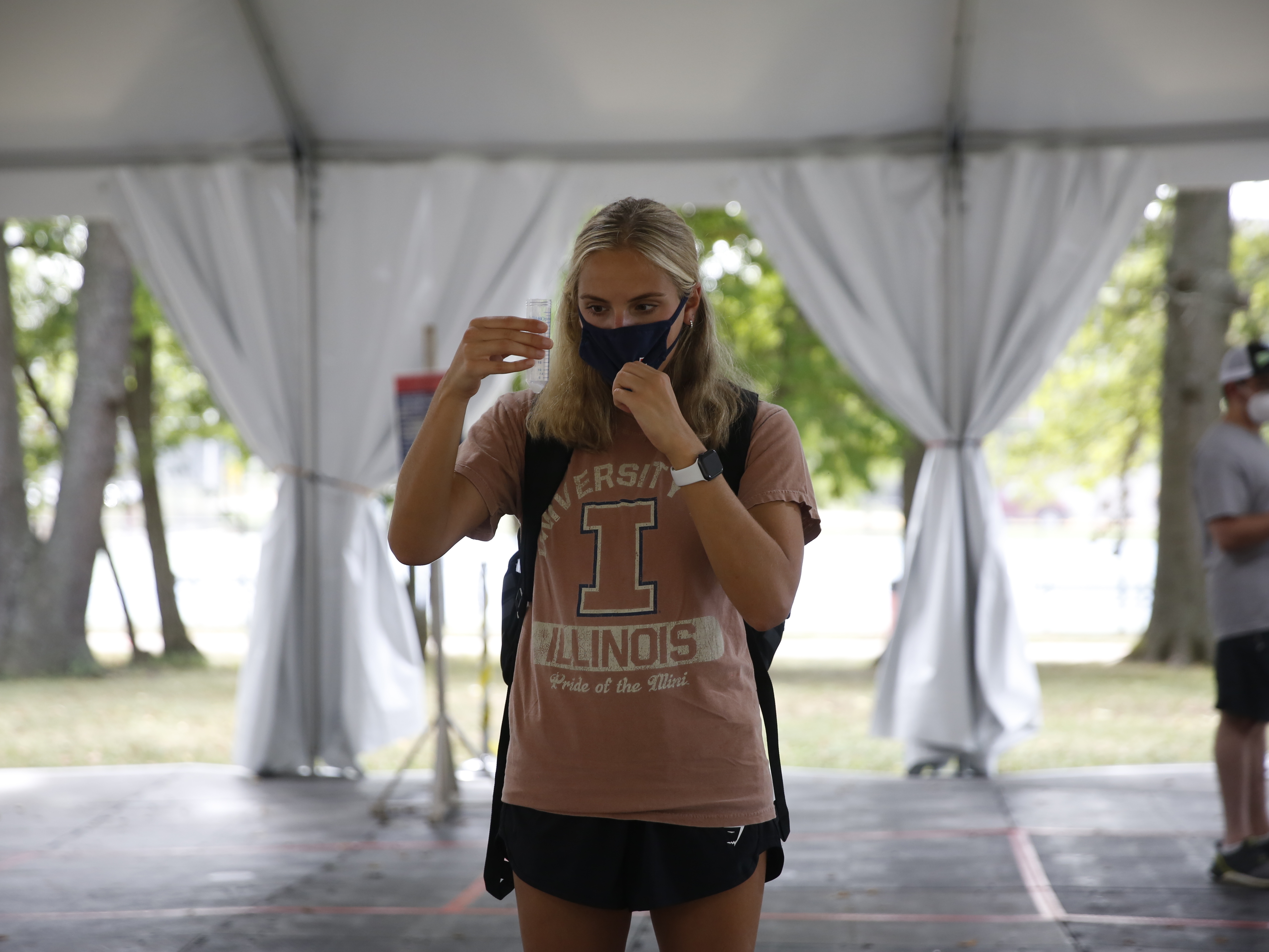 caption: Emily Garti, a junior studying nutrition, gets her twice-weekly COVID-19 test at the University of Illinois at Urbana-Champaign.