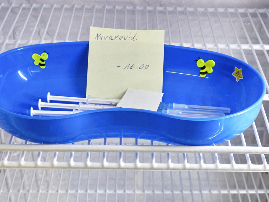 caption: A kidney dish with syringes containing the Novavax COVID-19 vaccine sits in a refrigerator ready for use in February at a vaccination center in Prisdorf, Germany.
