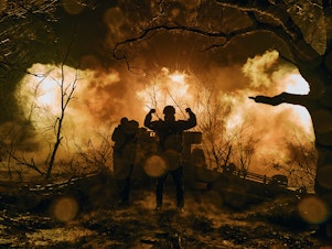 caption: Ukrainian soldiers fire artillery towards Russian positions near the eastern town of Bakhmut in November 2022.