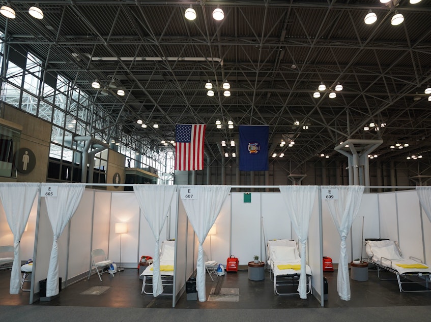 caption: Authorities are setting up a temporary hospital with 1,000 beds at the Jacob K. Javits Center, seen here Friday in New York City. The city is bracing for an overwhelming tide of patients, as its number of confirmed cases continues to rise.