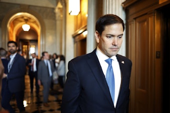 caption: Sen. Marco Rubio (R-FL) leaves the Senate chamber in May.