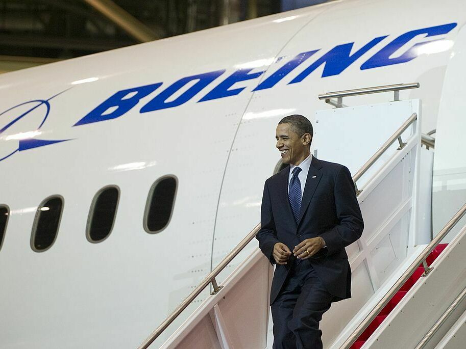caption: Then-President Barack Obama walks down the stairs of a Boeing 787 Dreamliner at the company's production facility in Everett, Wash., in 2012.