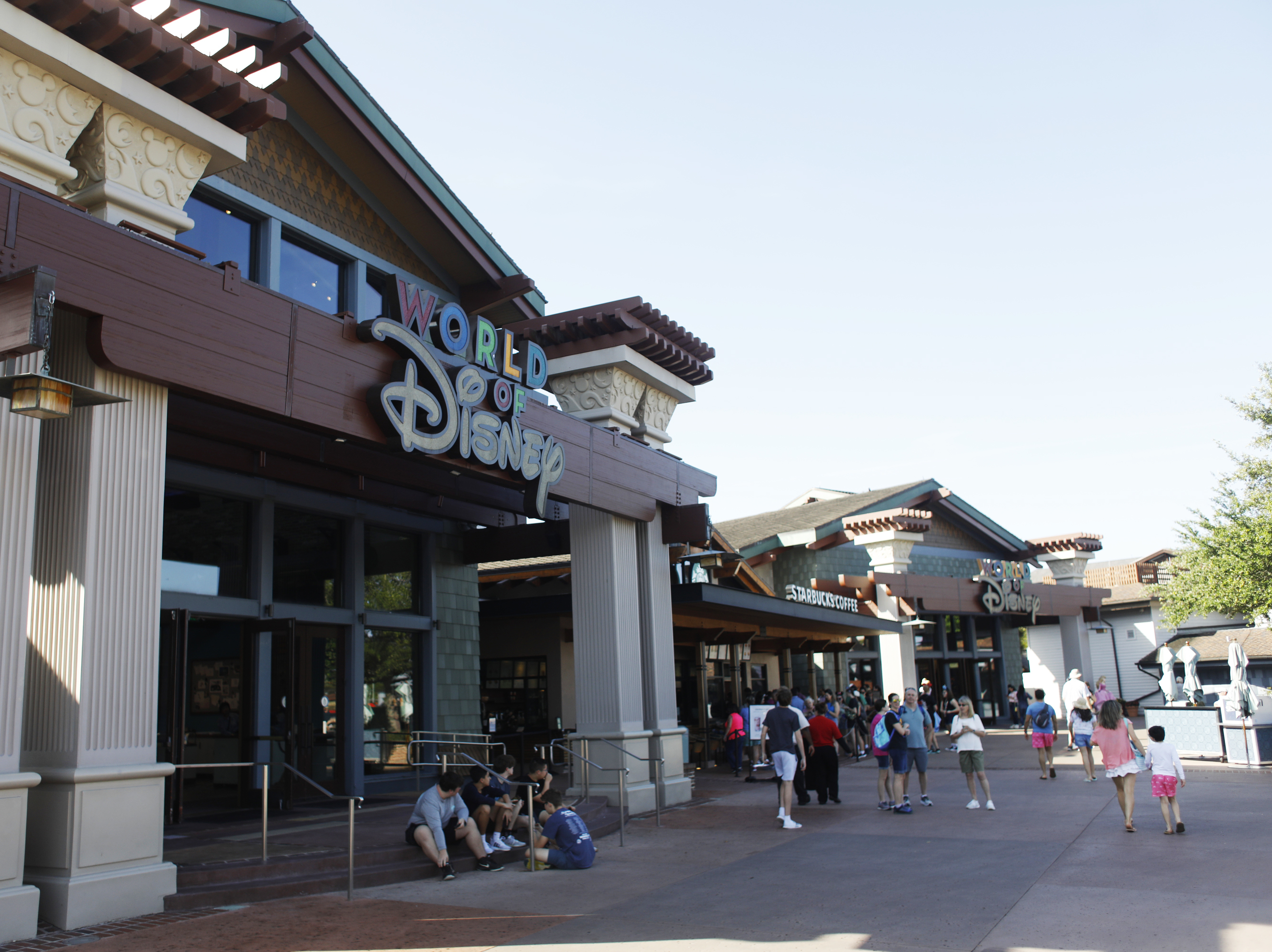 caption: Disney operates like its own county government in Florida — but that could change, if Gov. Ron DeSantis signs a new bill lawmakers approved this week. Here, tourists walk through Disney Springs at Walt Disney World in Orlando, Fla., last month.