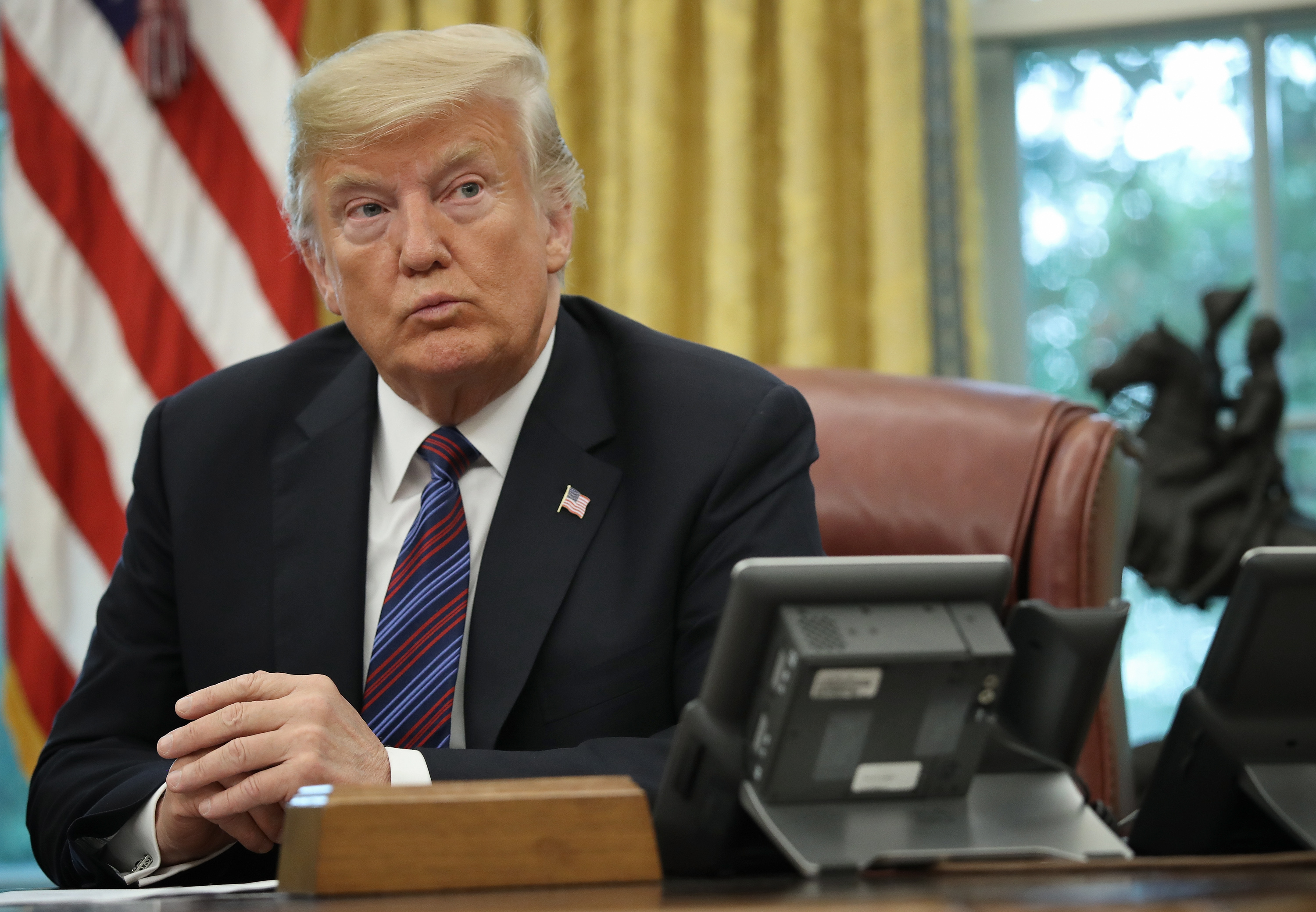 caption: President Donald Trump speaks on the telephone via speakerphone with Mexican President Enrique Pena Nieto in the Oval Office of the White House on August 27, 2018 in Washington, DC. (Win McNamee/Getty Images)