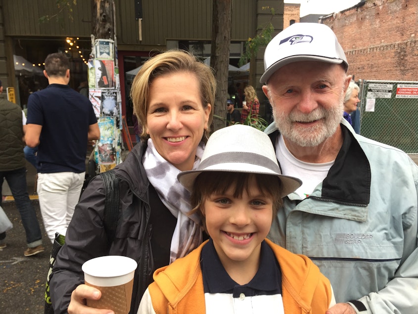 caption: Holly Smith, Holly's son Oliver, and farmer Bill Davidson at the Ballard Farmers' Market.