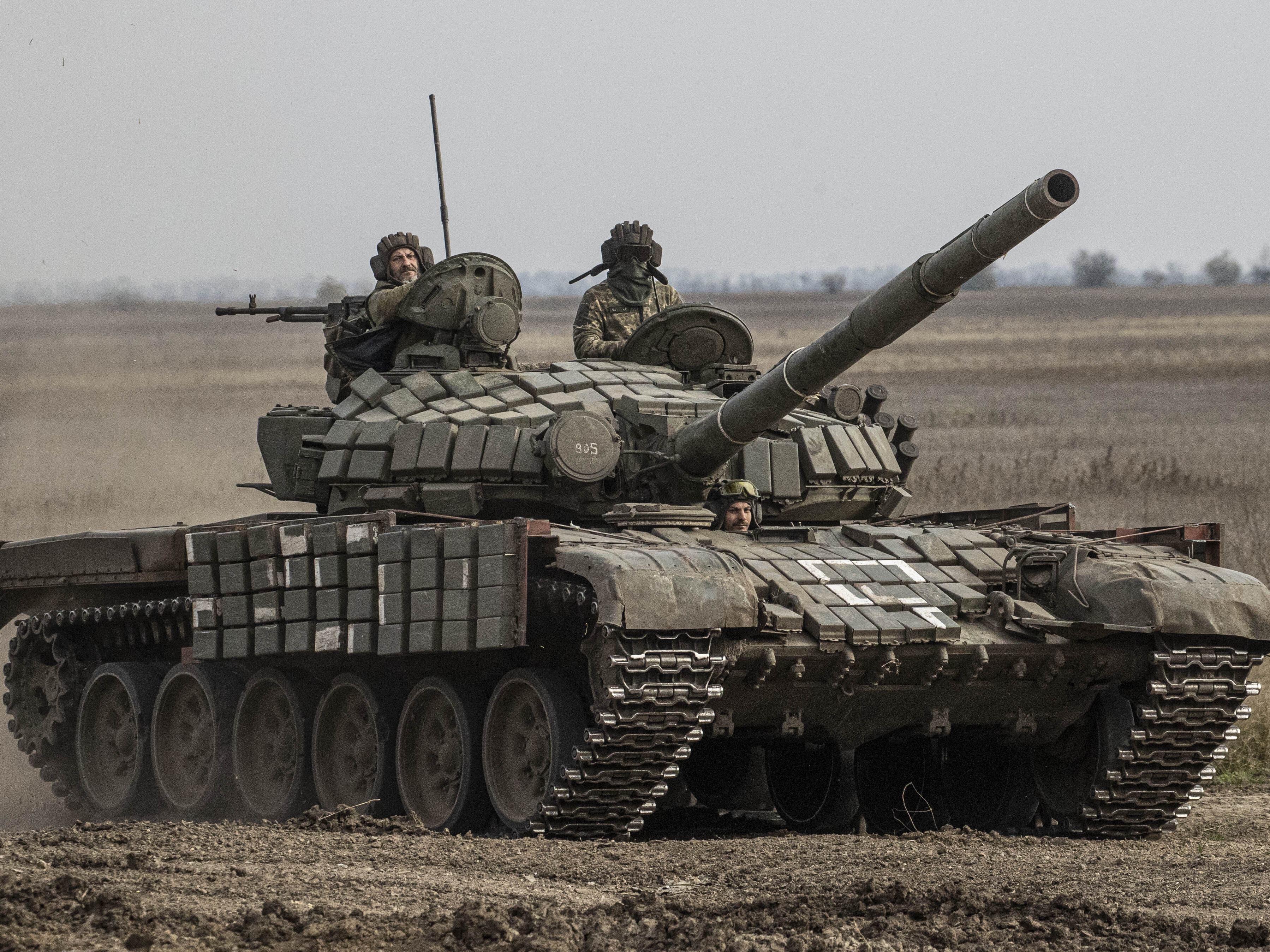 caption: Ukrainian Armed Forces in a tank heading toward the Kherson front in Kherson region on Wednesday.