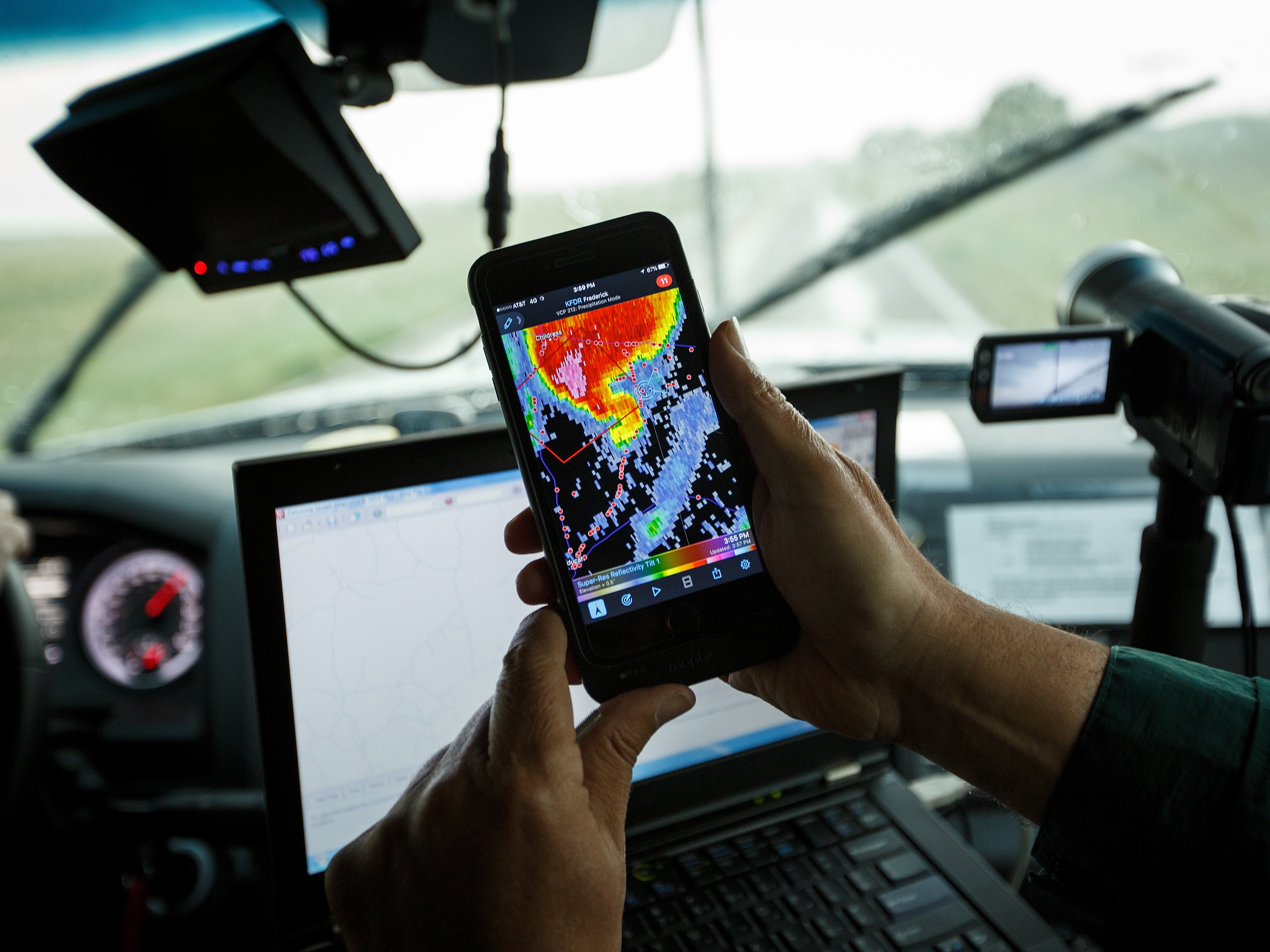 caption: A support scientist looks at radar on his phone while tracking a supercell thunderstorm in Oklahoma. Hail damage contributed to $51 billion in insured losses last year from severe storms, according to the Insurance Information Institute, an industry-backed think tank.