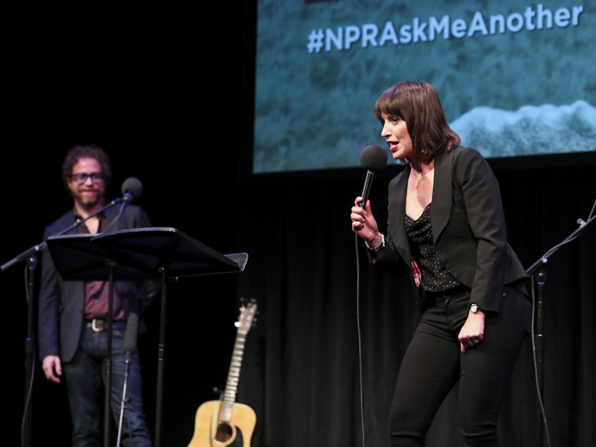 caption: Host Ophira Eisenberg performs stand up on <em>Ask Me Another</em> at the Balboa Theatre in San Diego, California.