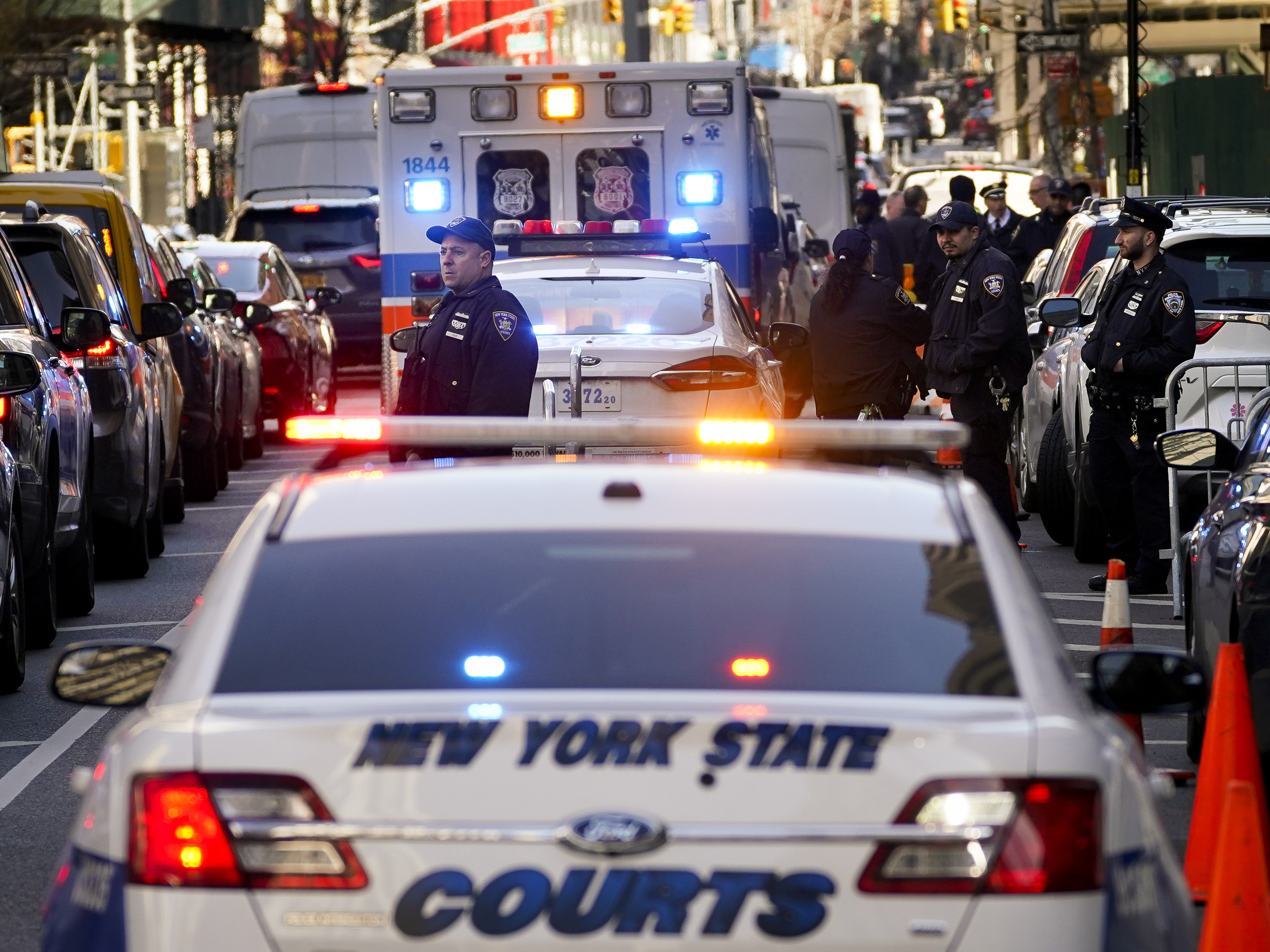 caption: Police and court security at the Manhattan Criminal Court, where former President Donald Trump is scheduled to be arraigned on Tuesday.