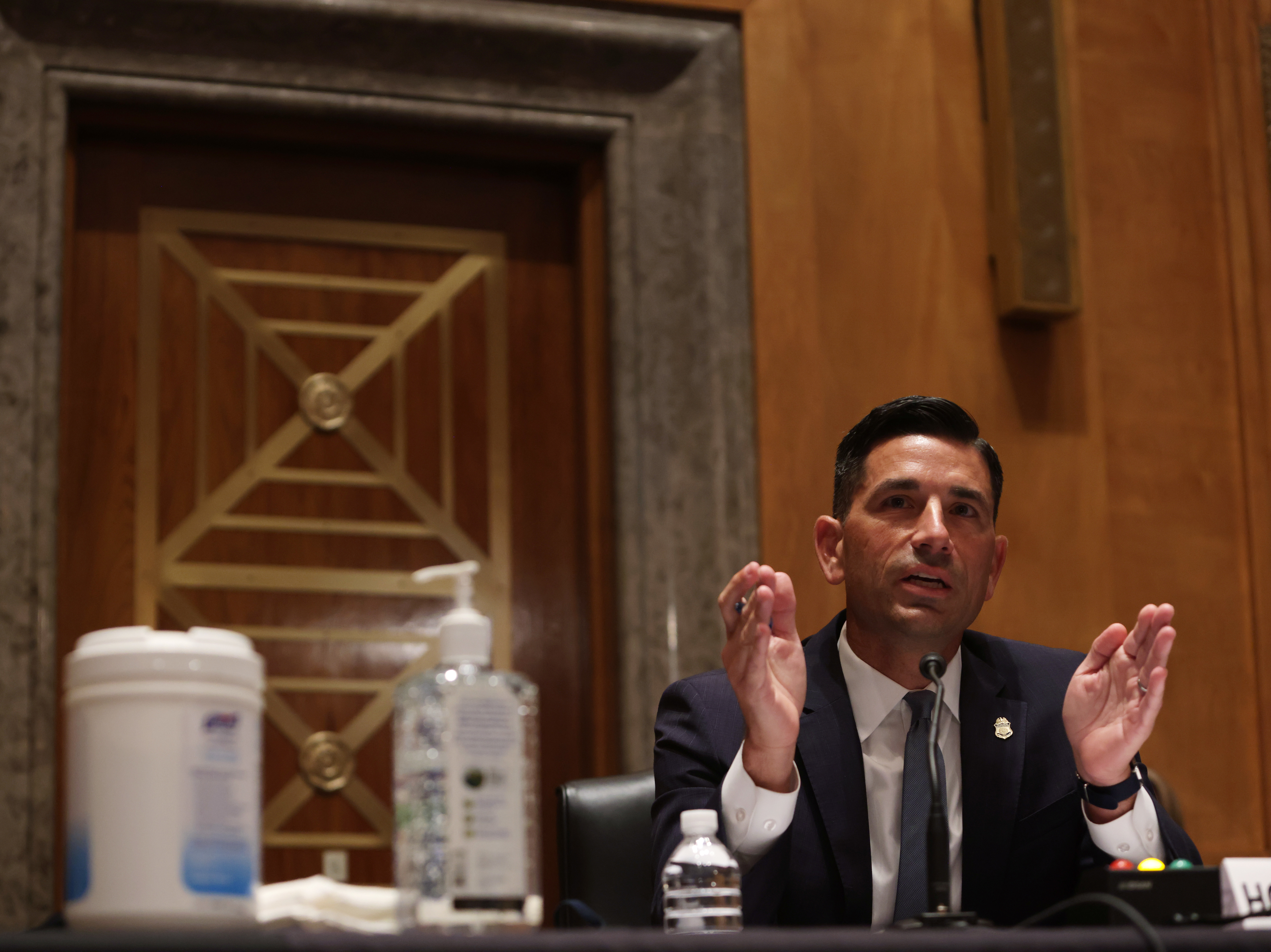 caption: Acting U.S. Secretary of Homeland Security Chad Wolf testifies during a hearing before the Senate Homeland Security and Governmental Affairs Committee on Capitol Hill in Washington, D.C., on August 6.