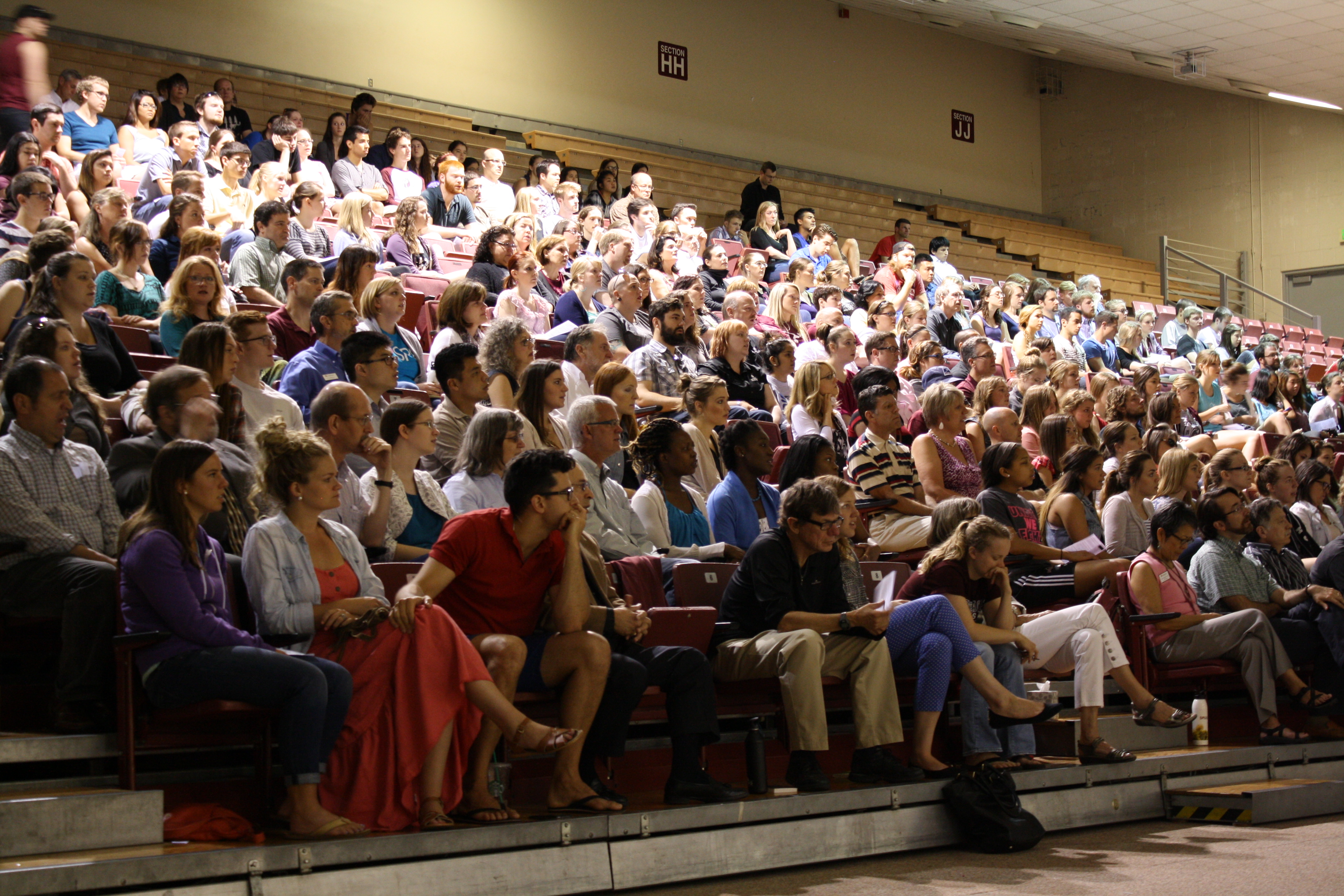 caption: The day after the shooting, a service was held at SPU. The church was filled to capacity so a gymnasium was used for overflow.