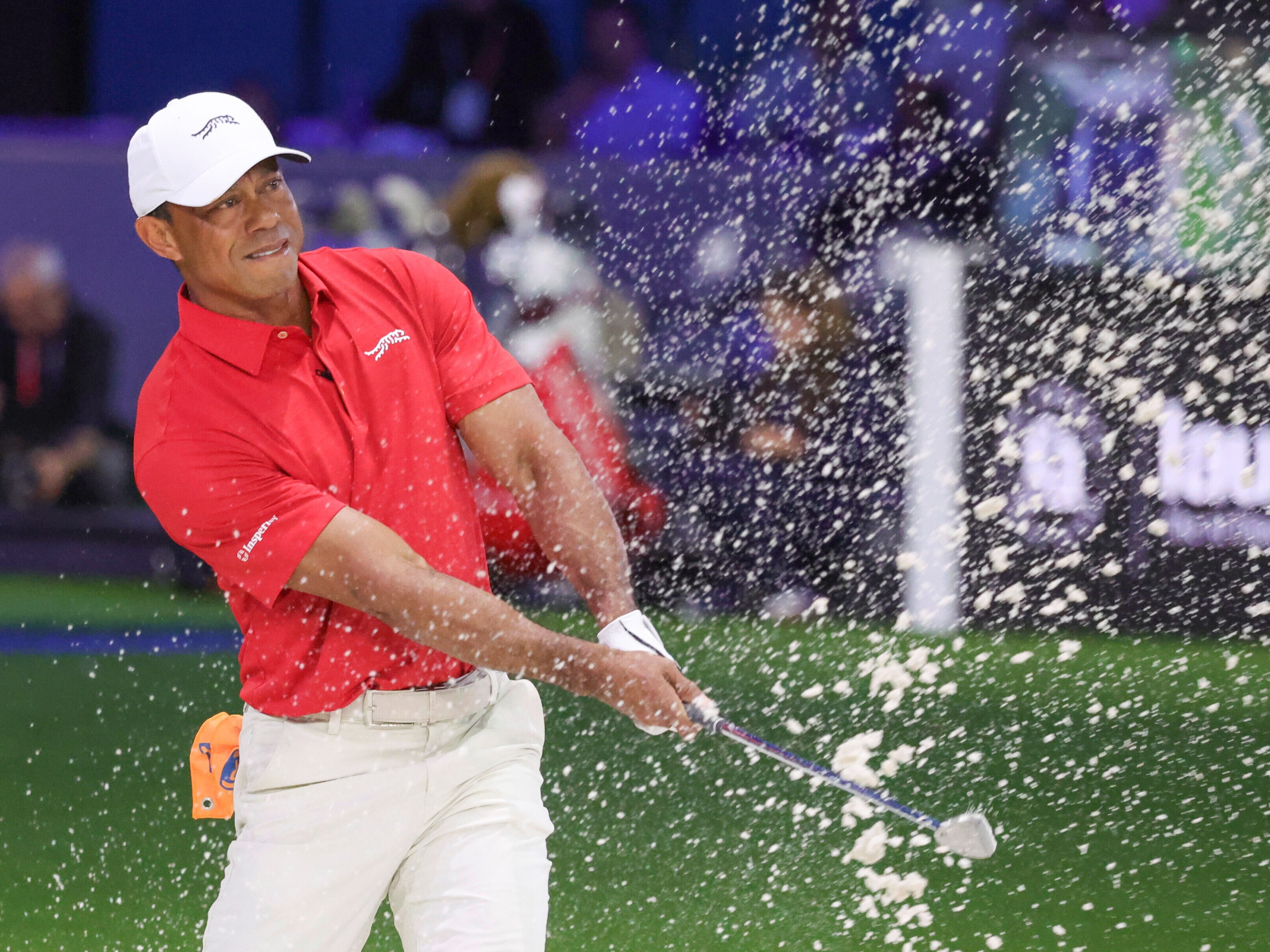 caption: Tiger Woods of the Jupiter Links Golf Club plays a shot from a bunker on the eighth hole, during final day of TGL golf tournament, Tuesday, March 24, 2026, in Palm Beach Gardens Fla.