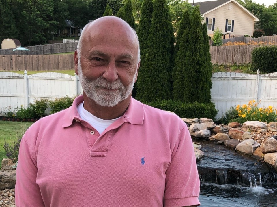 caption: Portrait of Phillip Lyn taken by his spouse, Kurt Rehwinkel, outside their home in St. Louis.
