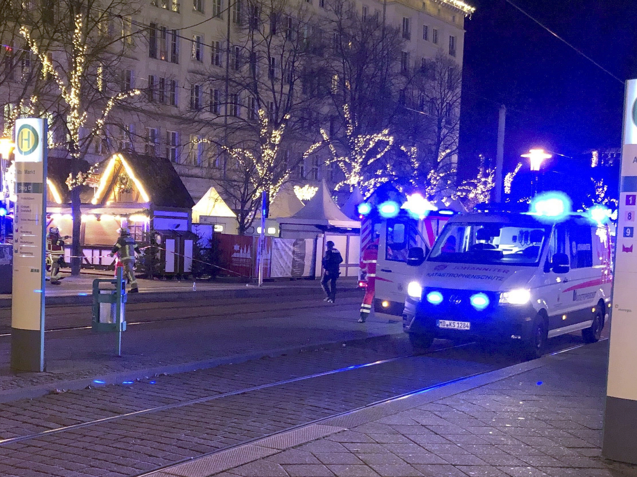 caption: Emergency services attend an incident at the Christmas market in Magdeburg, Germany, on Friday.