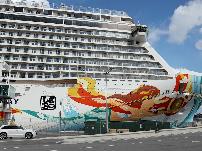 caption: The Norwegian Gateway cruise ship is moored at PortMiami on Jan. 7 in Miami. The Centers for Disease Control and Prevention dropped its advisory warning Wednesday for cruise travel after more than two years of warning Americans.