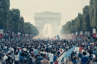 caption: Ladj Ly's 2019 film<em> Les Misérables </em>opens on an ecstatic scene — France has just won the World Cup and happy Parisians are celebrating in the streets.