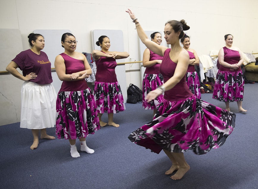 caption: Taylor Johnson, 23, twirls in her 'Auana dress during practice on Thursday, March 22, 2018, at the halau in Federal Way. 