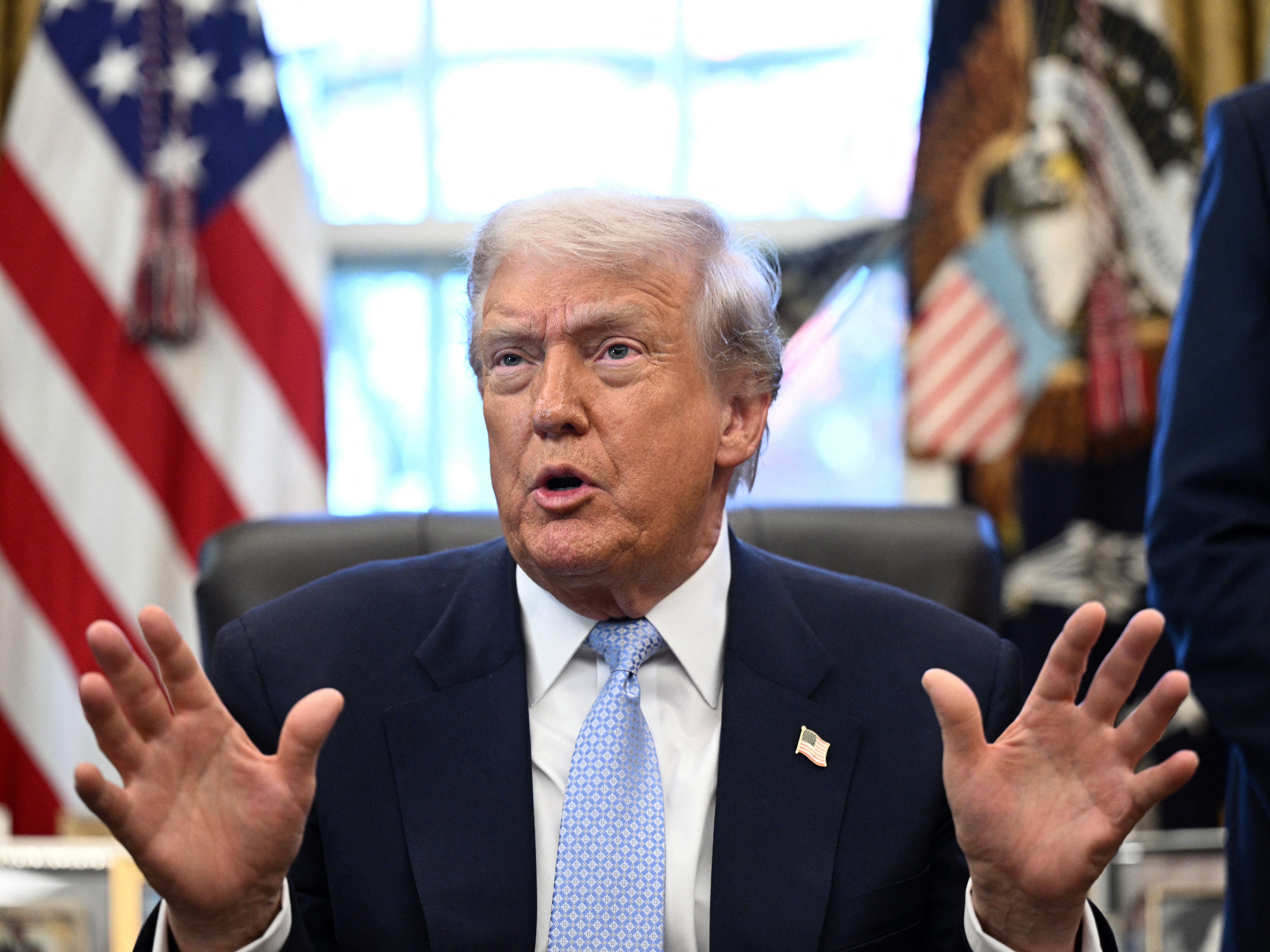 caption: President Trump speaks with reporters from the Oval Office on Monday. Trump said he would sign a bill to release the Epstein files if it passes through Congress.