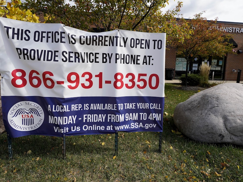 caption: A sign outside a U.S. Social Security Administration office in Mount Prospect, Ill., in October last year. Closed SSA offices across the country are being blamed for a 30 percent drop in applications for an aid program for the most vulnerable.