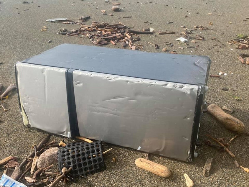 caption: A storm-battered refrigerator washed up on a beach near Cape Scott and the northwest tip of Vancouver Island on Wednesday