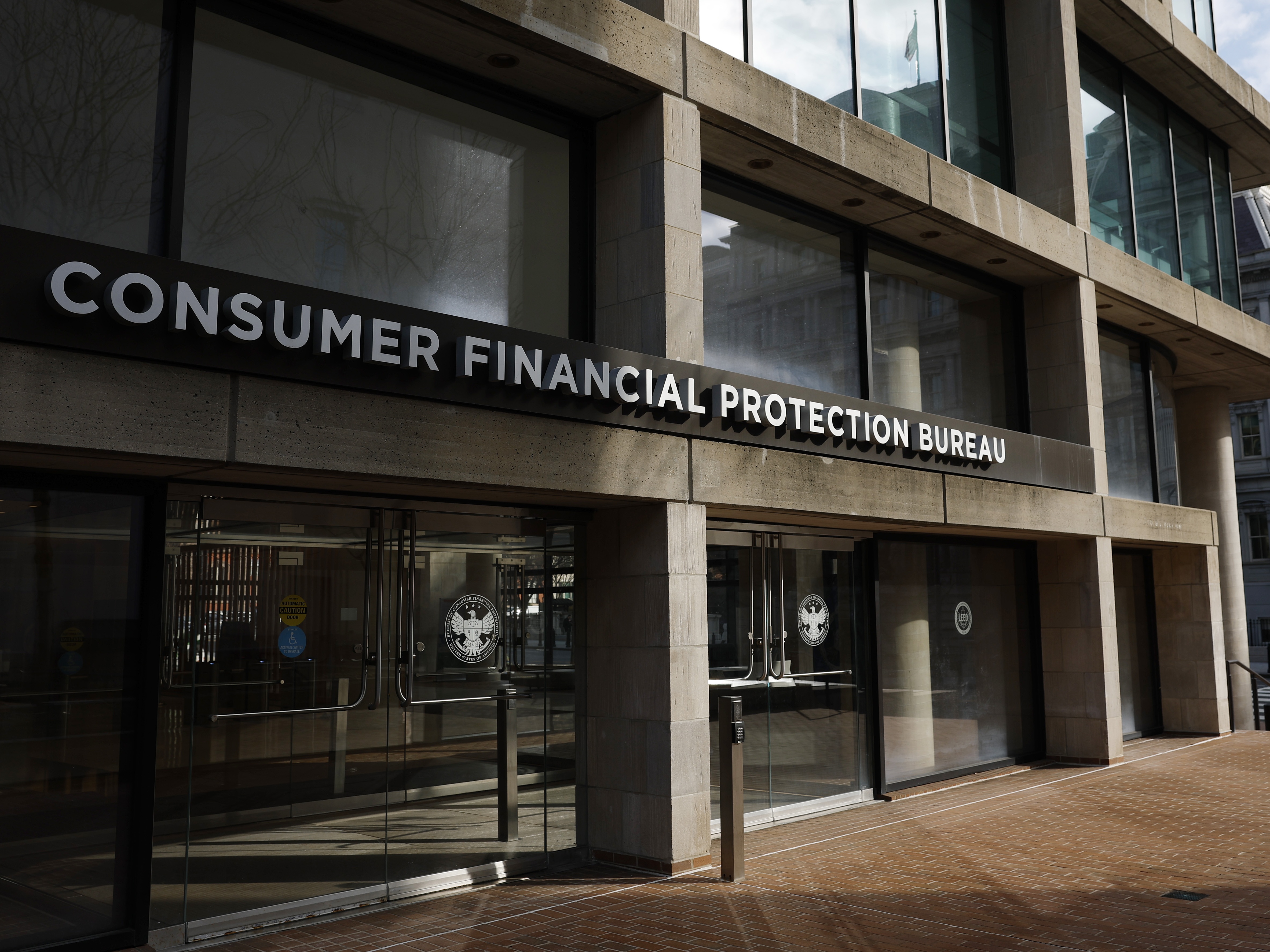 caption: The exterior of the Consumer Financial Protection Bureau headquarters in Washington, D.C. Employees of the CFPB were notified that the headquarters would be closed and that employees were to work from home.
