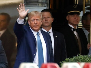 caption: Former President Donald Trump leaves Trump Tower on April 13 in New York City. A trial is set to begin Monday over allegations that Trump and his associates, including some of his children, committed fraud to do business.