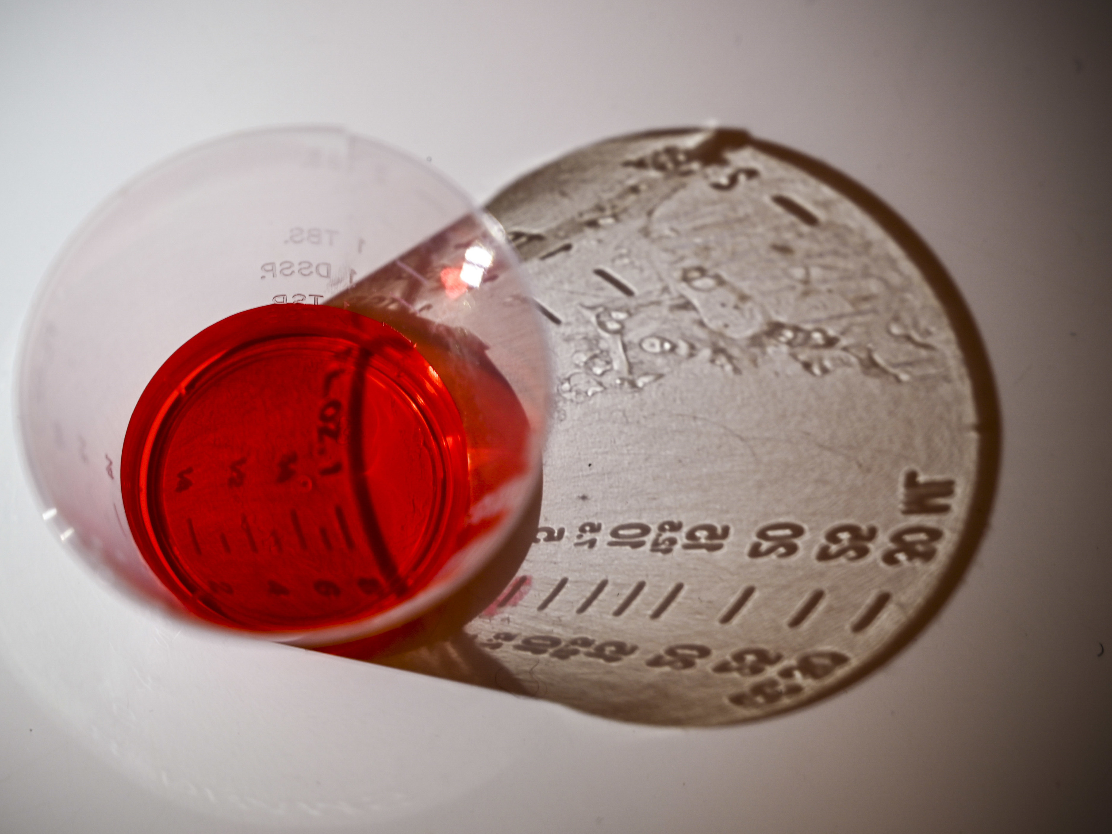 caption: A 5ml dose of liquid oxycodone, an opioid pain relief medication, sits on a table in Washington, D.C., March 29, 2019. During the opioid epidemic, roughly 218,000 Americans have died from overdoses tied to prescription pain pills, according to the Centers for Disease Control and Prevention.